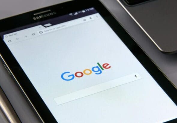 Close-up of a tablet displaying Google's search screen, emphasizing technology and internet browsing.